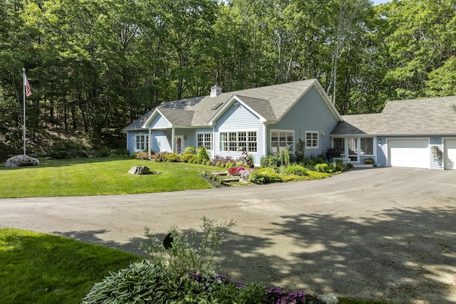 28 Evergreen Dr, Boothbay, ME 04537 - view of front of house with a chimney, a front lawn, an attached garage, driveway, and a shingled roof