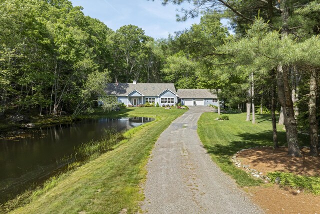 28 Evergreen Dr, Boothbay, ME 04537 - ranch-style house featuring driveway, a garage, a water view, and a front yard
