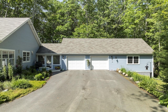 28 Evergreen Dr, Boothbay, ME 04537 - view of front facade with driveway, a garage, and roof with shingles