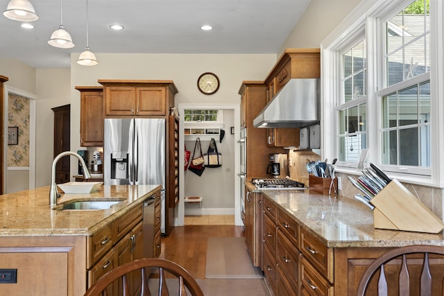 28 Evergreen Dr, Boothbay, ME 04537 - kitchen featuring extractor fan, brown cabinets, stainless steel appliances, light stone countertops, and recessed lighting