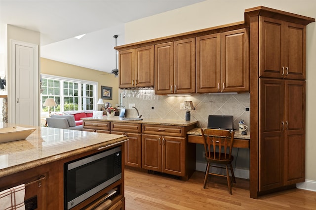 28 Evergreen Dr, Boothbay, ME 04537 - kitchen with stainless steel microwave, light wood-type flooring, decorative backsplash, and light stone counters