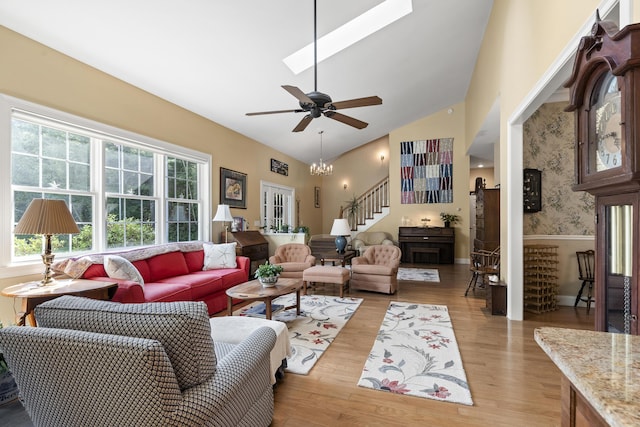 28 Evergreen Dr, Boothbay, ME 04537 - living room featuring stairs, light wood-type flooring, ceiling fan, a skylight, and wainscoting