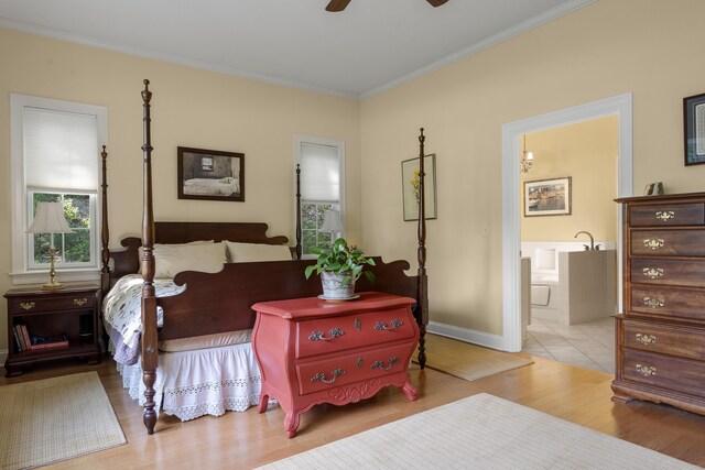 28 Evergreen Dr, Boothbay, ME 04537 - bedroom with wood finished floors, crown molding, connected bathroom, and ceiling fan