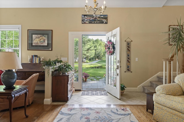 28 Evergreen Dr, Boothbay, ME 04537 - entrance foyer with a chandelier, light wood-style flooring, stairway, and a baseboard radiator