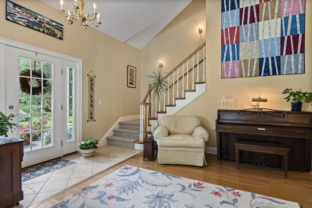 28 Evergreen Dr, Boothbay, ME 04537 - foyer entrance featuring stairs, high vaulted ceiling, a chandelier, and wood finished floors