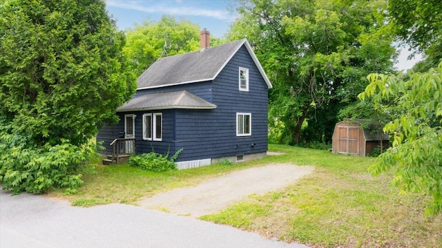 90 Newbury St, Auburn, ME 04210 - view of side of property featuring a shed, a chimney, and roof with shingles