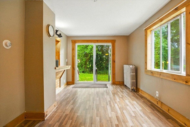 90 Newbury St, Auburn, ME 04210 - unfurnished room featuring radiator heating unit and wood finished floors