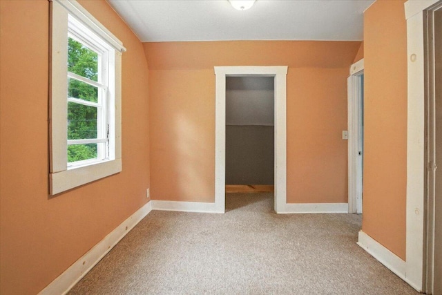 90 Newbury St, Auburn, ME 04210 - unfurnished bedroom featuring carpet floors, a walk in closet, and a closet