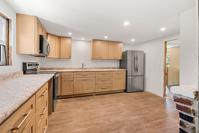 276 W St, Biddeford, ME 04005 - kitchen with stainless steel appliances, light wood-style floors, recessed lighting, light brown cabinets, and light stone counters