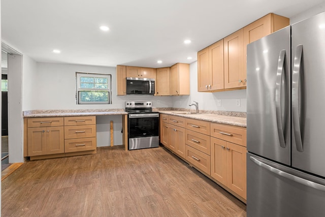 276 W St, Biddeford, ME 04005 - kitchen with stainless steel appliances, light wood-style flooring, light brown cabinets, and recessed lighting