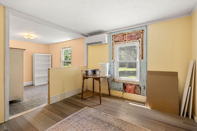 276 W St, Biddeford, ME 04005 - dining space with a wall mounted AC, wood finished floors, and a textured ceiling