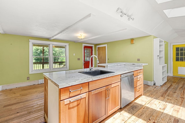 276 W St, Biddeford, ME 04005 - kitchen featuring dishwasher, a skylight, light wood finished floors, and an island with sink