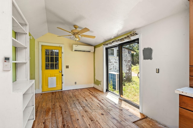 276 W St, Biddeford, ME 04005 - foyer entrance with an AC wall unit, vaulted ceiling, a ceiling fan, and hardwood / wood-style flooring