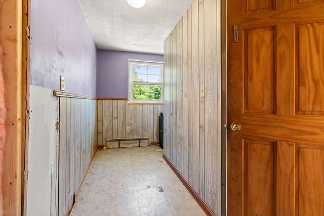 276 W St, Biddeford, ME 04005 - bathroom featuring wooden walls, a textured ceiling, and tile patterned floors