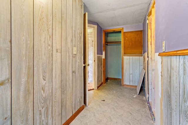 276 W St, Biddeford, ME 04005 - hall featuring a textured ceiling and wood walls