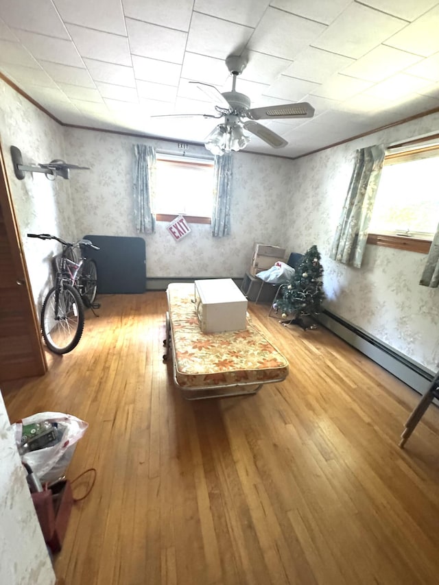 5 Park Ave, Newport, ME 04953 - bedroom with hardwood / wood-style flooring, a ceiling fan, wallpapered walls, and a paneled ceiling