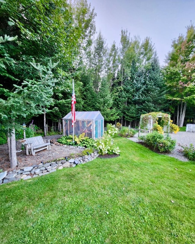 178 Kennebago Rd, Coplin Plt, ME 04970 - view of green lawn featuring a greenhouse and an outdoor structure