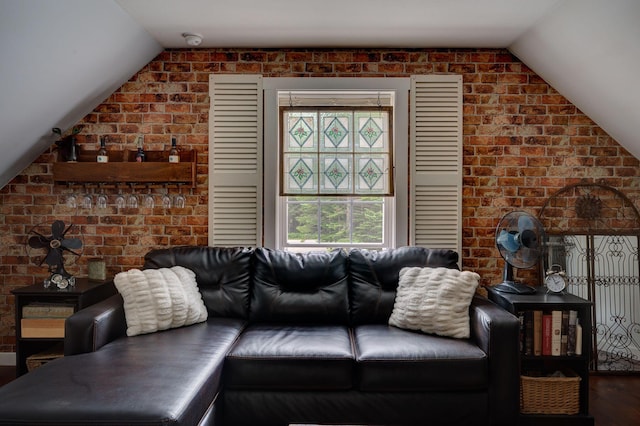 178 Kennebago Rd, Coplin Plt, ME 04970 - living room with lofted ceiling, wood finished floors, and brick wall