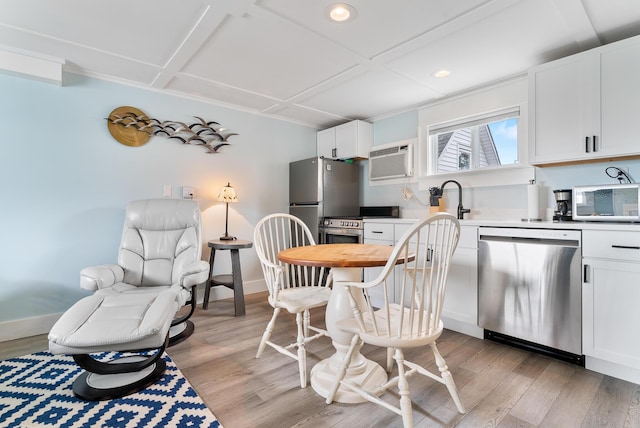 7 Bay Ave Unit 11, Old Orchard Beach, ME 04064 - kitchen with stainless steel appliances, light wood finished floors, a wall unit AC, light countertops, and recessed lighting