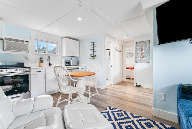 7 Bay Ave Unit 11, Old Orchard Beach, ME 04064 - kitchen featuring stainless steel electric range, recessed lighting, light wood-type flooring, white cabinetry, and light countertops