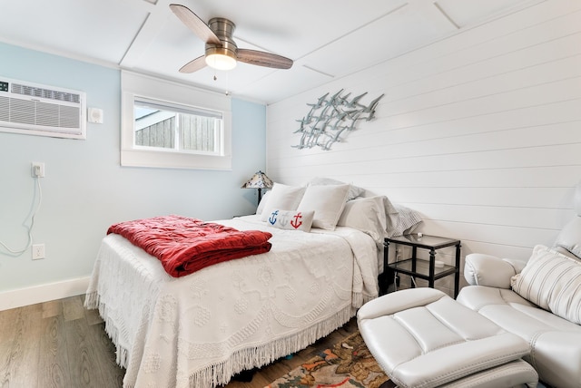7 Bay Ave Unit 11, Old Orchard Beach, ME 04064 - bedroom featuring wood finished floors, an AC wall unit, and ceiling fan