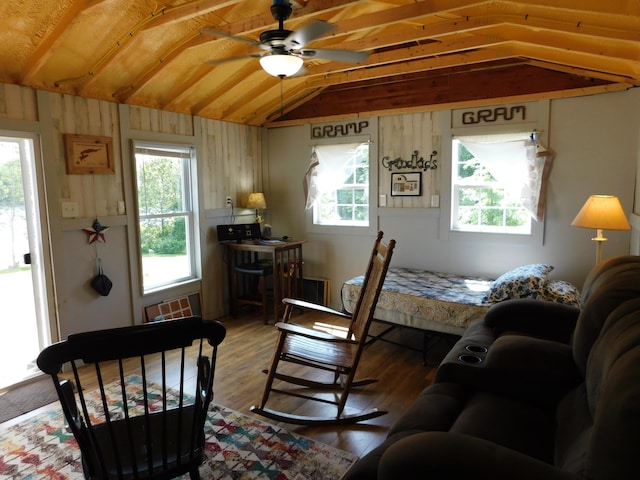 208 Fern Rd, Dexter, ME 04930 - living room with light wood-style floors, ceiling fan, and wooden walls
