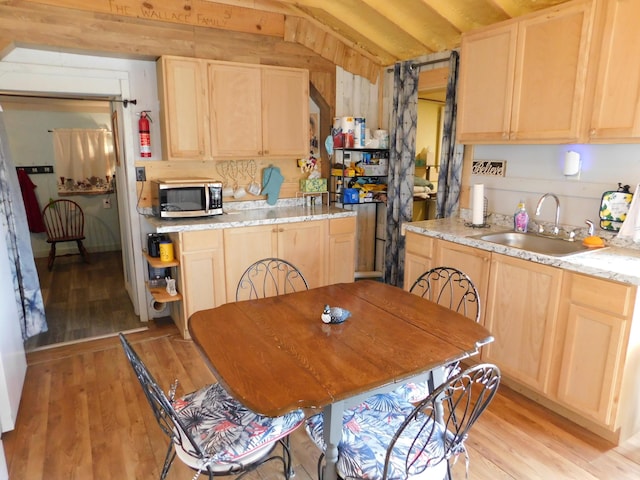 208 Fern Rd, Dexter, ME 04930 - kitchen featuring stainless steel microwave, light brown cabinets, and light wood-style floors