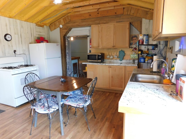 208 Fern Rd, Dexter, ME 04930 - kitchen with white appliances, lofted ceiling, light brown cabinetry, wooden walls, and light wood-style floors