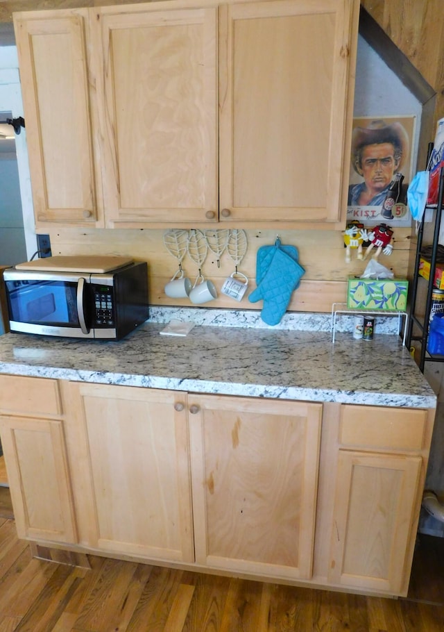 208 Fern Rd, Dexter, ME 04930 - kitchen with light brown cabinetry, stainless steel microwave, and wood finished floors