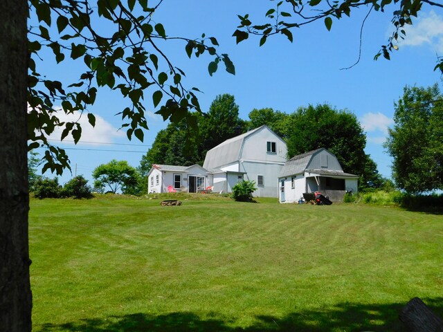 208 Fern Rd, Dexter, ME 04930 - view of green lawn featuring an outdoor fire pit and an outbuilding