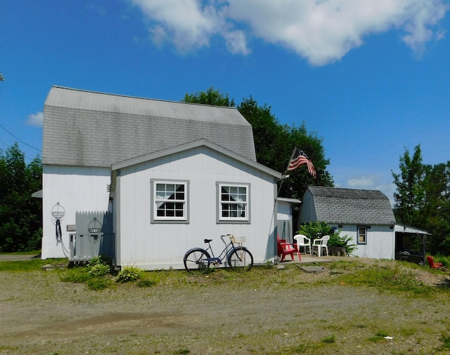 208 Fern Rd, Dexter, ME 04930 - rear view of property featuring a gambrel roof and roof with shingles