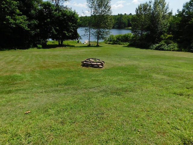 208 Fern Rd, Dexter, ME 04930 - view of green lawn featuring a water view and an outdoor fire pit