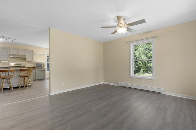 102 Mountain View Rd, Leeds, ME 04263 - spare room with a baseboard radiator, wood finished floors, and ceiling fan