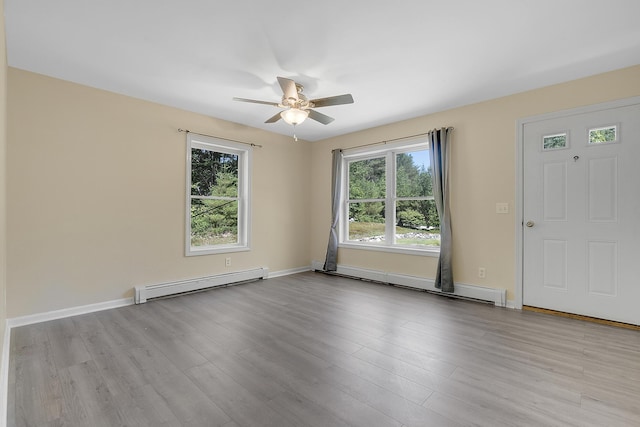 102 Mountain View Rd, Leeds, ME 04263 - empty room featuring a baseboard radiator, a ceiling fan, and plenty of natural light