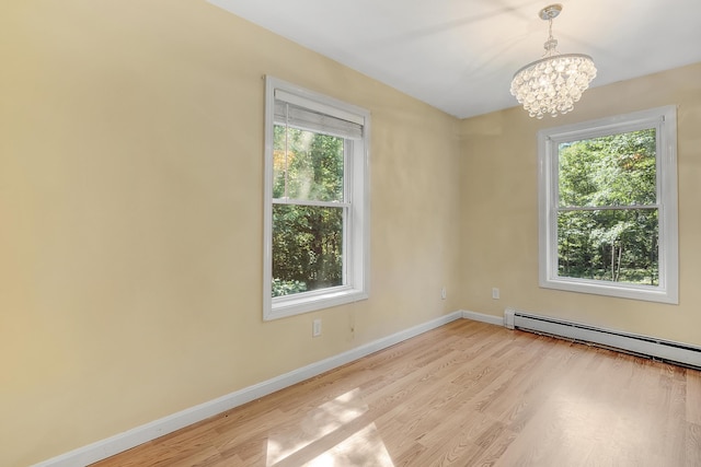 102 Mountain View Rd, Leeds, ME 04263 - unfurnished room featuring plenty of natural light, a baseboard radiator, wood finished floors, and a chandelier
