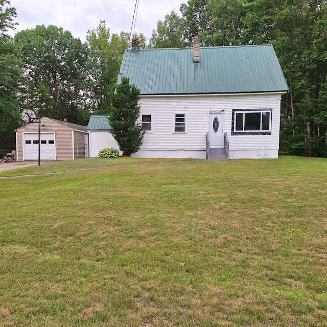 167 Mechanic Falls Rd, Poland, ME 04274 - view of front of house featuring a chimney, an outdoor structure, a metal roof, a detached garage, and a front yard