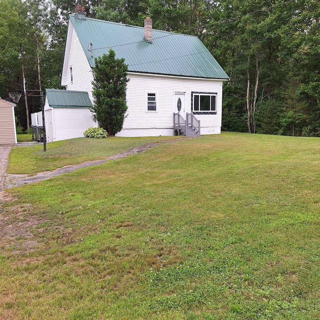 167 Mechanic Falls Rd, Poland, ME 04274 - rear view of house with a chimney, entry steps, a yard, and a metal roof