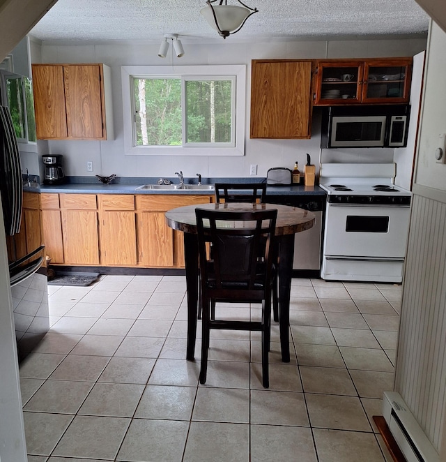 167 Mechanic Falls Rd, Poland, ME 04274 - kitchen featuring stainless steel microwave, white range with electric stovetop, a baseboard heating unit, fridge, and a textured ceiling