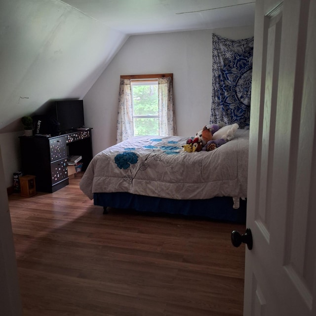 167 Mechanic Falls Rd, Poland, ME 04274 - bedroom featuring wood finished floors and vaulted ceiling
