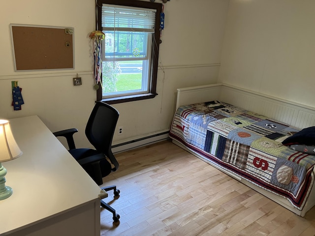 363 Oak Point Rd, Trenton, ME 04605 - bedroom with a baseboard radiator, light wood-style floors, and an office area