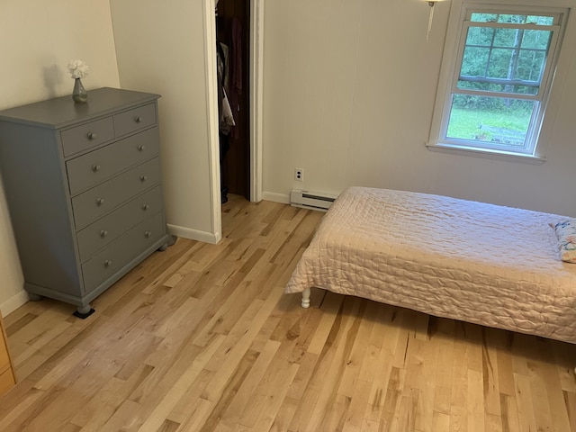 363 Oak Point Rd, Trenton, ME 04605 - bedroom featuring a baseboard radiator and light wood-style flooring
