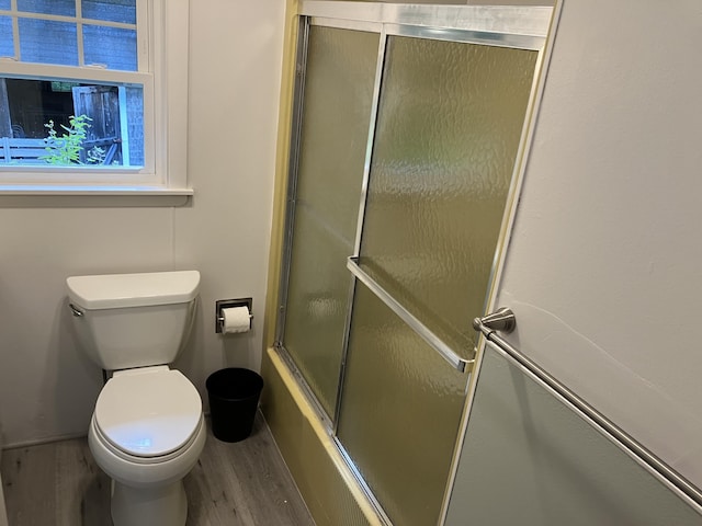 363 Oak Point Rd, Trenton, ME 04605 - full bathroom featuring wood finished floors and bath / shower combo with glass door