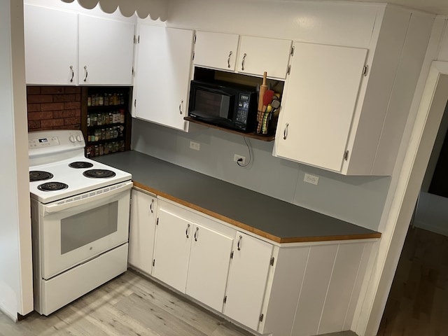 363 Oak Point Rd, Trenton, ME 04605 - kitchen featuring white range with electric stovetop, black microwave, light wood finished floors, dark countertops, and white cabinetry