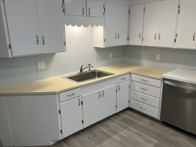 363 Oak Point Rd, Trenton, ME 04605 - kitchen featuring stainless steel dishwasher, light countertops, light wood-style flooring, and white cabinets