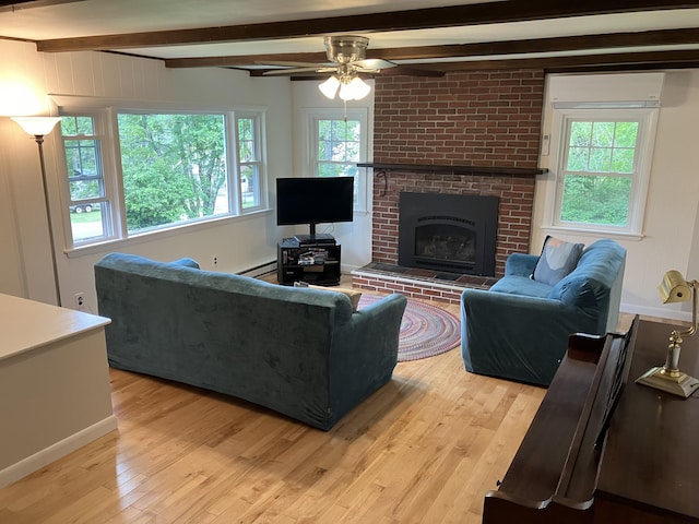 363 Oak Point Rd, Trenton, ME 04605 - living room featuring beamed ceiling, light wood-type flooring, a ceiling fan, a brick fireplace, and a wall mounted AC