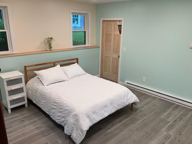 363 Oak Point Rd, Trenton, ME 04605 - bedroom with a baseboard heating unit and wood finished floors