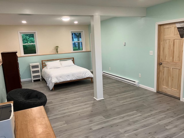 363 Oak Point Rd, Trenton, ME 04605 - bedroom featuring a baseboard radiator, wood finished floors, and recessed lighting