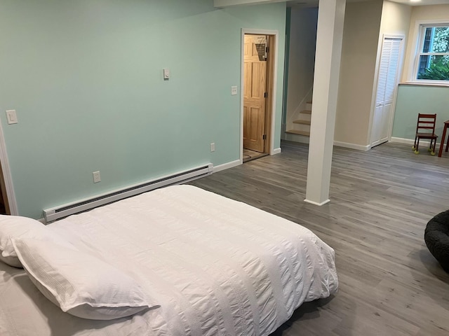 363 Oak Point Rd, Trenton, ME 04605 - bedroom featuring a baseboard heating unit and wood finished floors