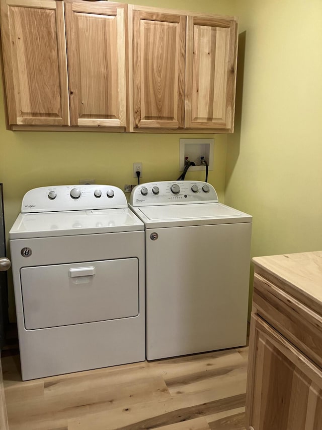 363 Oak Point Rd, Trenton, ME 04605 - washroom with cabinet space, washer and dryer, and light wood-style flooring