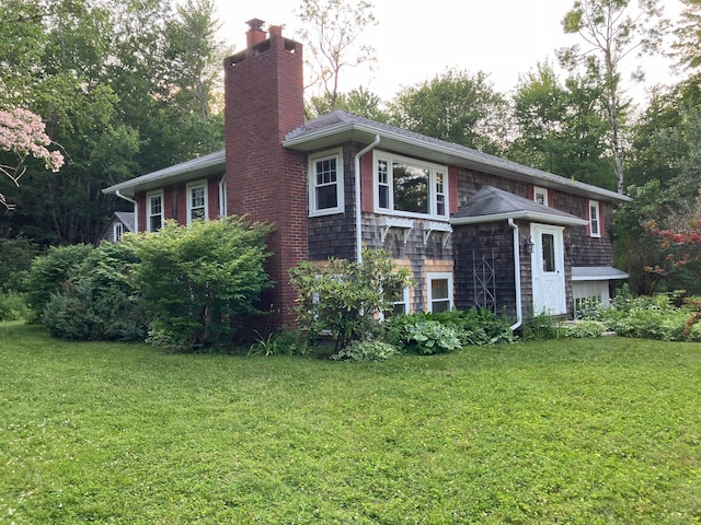 363 Oak Point Rd, Trenton, ME 04605 - view of home's exterior with a chimney and a lawn